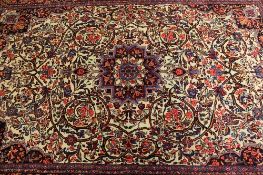 An Iranian wool carpet, on cream ground, 224 cm x 148 cm.