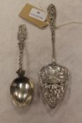 A continental silver slice, with engraved decoration, together with a silver spoon of the same