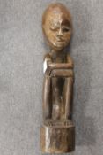 A large African carving depicting a man sitting, height 68 cm. CONDITION REPORT: Good condition.