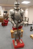 A suit of armour together with broad sword and helmet. CONDITION REPORT: Good condition, date