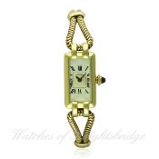 A LADIES 18K SOLID GOLD CARTIER BRACELET WATCH CIRCA 1930s D: White enamel dial with Roman numerals.