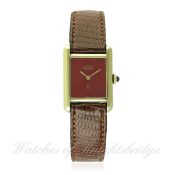 A LADIES SILVER GILT MUST DE CARTIER WRIST WATCH CIRCA 1990s D: Red lacquer dial with gilt hands. M: