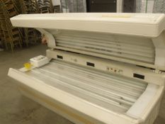 Ultra Sun coin operated sunbed, cracked perspex on base