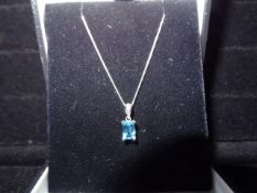 1 x 9 Carat White Gold Curb Chain with Blue Rectangular Topaz Pendant. Beautiful piece. Original