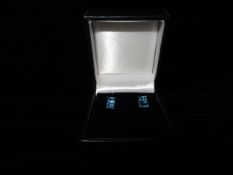 1 x Pair of 9 Carat White Gold Rectangular Blue Topaz Stud earrings. Brand new and Boxed.