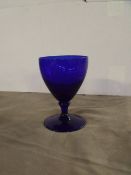 24 x blue glass drinking goblets in storage crate
