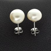 A beautiful pair of button shaped Cream Cultured Real Freshwater Pearl and Silver Earrings.