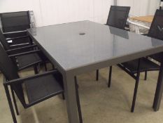 5 Piece Patio Set:
4 x black stacking chairs with textilene seat and back
glass top table marble