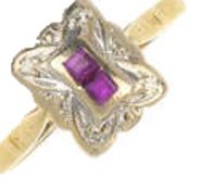 A Ruby and diamond ring in 18Ct gold. Two square cut ruby's with four single cut stones at each