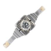 A mid 20th century platinum and 18ct gold diamond single-stone ring. The brilliant-cut diamond, to