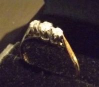 A three stone trilogy ring in 9 carat gold