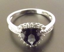 A stunning tanzanite and diamond ring, A trillion cut tanzanite stone surrounded by diamonds and set