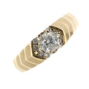 A 14ct gold diamond single-stone ring. The brilliant-cut diamond and similarly-cut diamond chevron