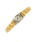 A diamond single stone ring stamped 18 ct gold. The brilliant cut diamond within a sqaure shaped