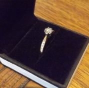 A 0.33 carat diamond solitiare ring in 18 carat gold. With futher diamonds along each shoulder