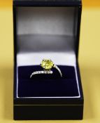A Sinlge Yellow diamond soltiare ring, set in a diamond encrusted white gold twist style ring. The