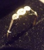 A three stone platinum and 18 carat gold ring, Three brilliant cut diamonds set in gold and