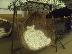 2 seater natural colour rattan swing chair, with a frame stand and sun shade