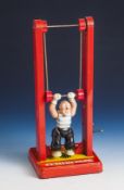 Gescha, Blechspielzeug, Nr. 575 M, Clown am Reck, 1950er Jahre, Blech/Kunststoff, Spileuhrm. Melodie