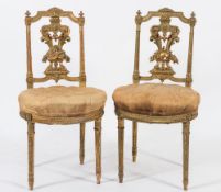 A set of four late 19th Century French carved giltwood salon chairs:,