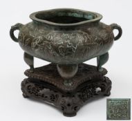 A Chinese bronze censer: of cartouche-shaped outline,