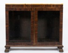An early 19th Century rosewood low bookcase:, surmounted by a panel of variegated peach marble,