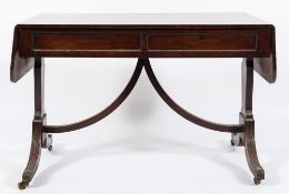 A Regency mahogany sofa table:, the hinged top with rounded corners,