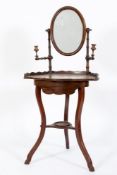 An early 19th Century mahogany shaving stand:, of lobed fronted outline,