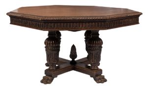 A Victorian carved oak octagonal library table:, the top with a gadrooned edge,