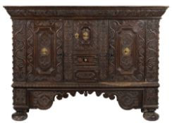 An 18h Century Continental carved oak side cupboard:,