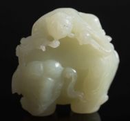 A Chinese celadon jade carving: of a man riding on the back of an elephant and holding a lingzhi