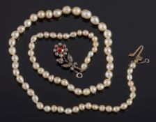 A natural pearl, possibly, single-string necklace: with ruby and diamond flower clasp,