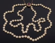 A graduated cultured pearl two-string necklace: with amethyst and seed-pearl clasp stamped '9ct',