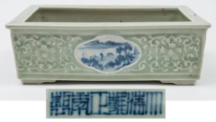 A Chinese porcelain celadon ground jardiniere: of shallow rectangular form with quadrilobed