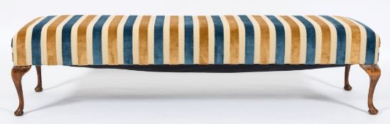 An upholstered window seat of large size:, with rectangular stuff over seat in blue,