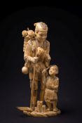 A Japanese carved ivory okimono: of a gardener holding a rake with a basket of flowers on his back