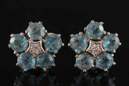 A pair of aquamarine and diamond circular cluster ear-studs: each with a central small diamond
