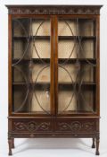 An Edwardian carved mahogany display cabinet:,