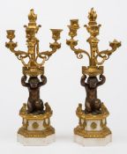 A pair of late 19th century bronze gilt brass and marble three branch garnitures: with urn shaped