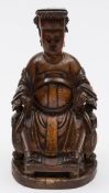 A Chinese carved wood figure: possibly an Emperor, wearing elaborate robes and seated on a throne,