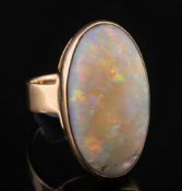 An oval opal single-stone dress ring:, the oval opal approximately 27mm total length,
