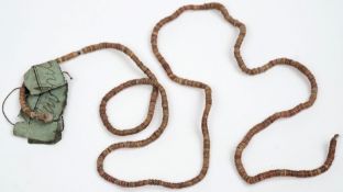 A Solomon Islands shell money necklace:, 58cm long with blue collection label attached.