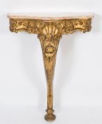 A carved giltwood serpentine fronted console table:,