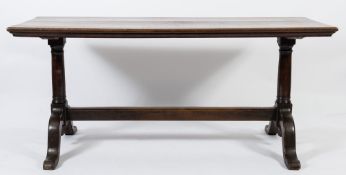 An 18th Century oak rectangular centre table:, on twin turned columns and dual splayed end supports,