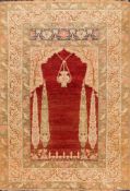 A Tabriz prayer rug:, the red mihrab with a design of a hanging lantern and cypress trees,