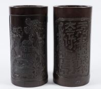 A pair of Chinese bamboo brush pots: of cylindrical form decorated with riverside landscape and