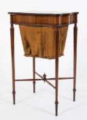 An Edwardian mahogany and inlaid work table:, of serpentine outline in the Sheraton taste,
