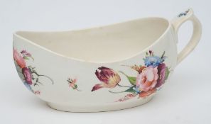 A mid 19th century English porcelain bourdaloue: painted with bouquets of flowers and scattered