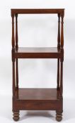 A Regency mahogany three-tier whatnot:, fitted with a drawer to the base, on bun feet,