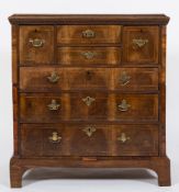 An 18th Century oak, pine and walnut fronted chest:, in two parts, the top with a moulded edge,